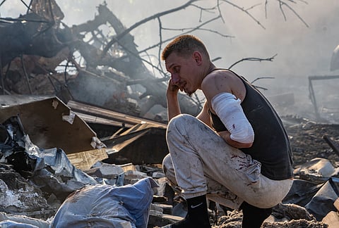 An injured man looks at his house destroyed in a Russian strike on Kharkiv, Ukraine, Sunday, Oct. 11, 2026. 
