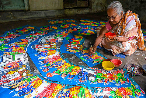 An octogenarian artisan paints designs on ‘chalchitra’, traditional decorative backdrop or semicircular halo placed behind Hindu idols, ahead of the ‘Durga Puja’ festival, in Nadia.
