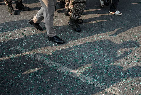 Shattered glass seen as National Students' Union of India (NSUI) activists stage a protest demanding the immediate resignation of Chief Election Commissioner (CEC) Gyanesh Kumar, at Connaught Place, in New Delhi, Tuesday, Oct. 13, 2026. 
