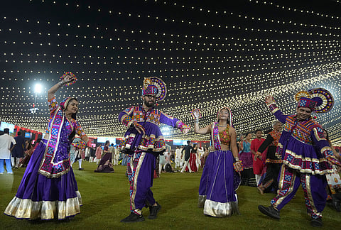 People in traditional attire perform Gujarat state's folk dance called Garba during the celebration of nine nights Hindu festival Navratri, in Ahmedabad, Monday, Oct. 12, 2026. 