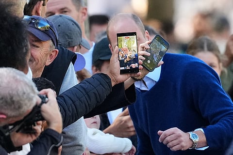 Britain's Prince William poses for pictures with members of the public as he joins cricketing stars from the United Kingdom and India at a special Earthshot Prize event in London, Tuesday, Oct. 13, 2026, ahead of the Earthshot Prize's annual Summit and Awards Night in Mumbai in November.