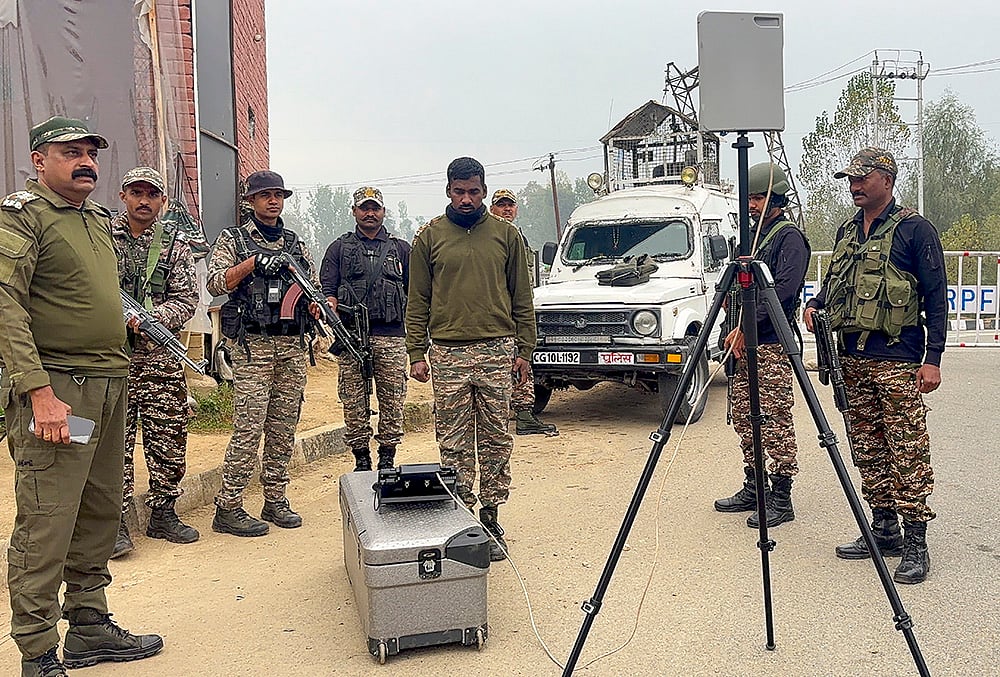 CRPF personnel conduct area surveillance using a drone to ensure security, in Anantnag. - | Photo: PTI