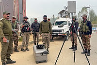 Day In Pics: October 13, 2026 | Photo: PTI : CRPF personnel conduct area surveillance using a drone to ensure security, in Anantnag.