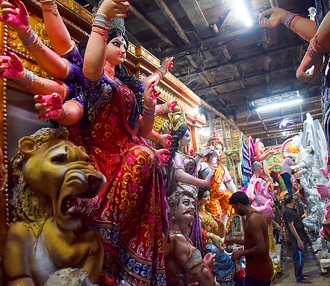 Artisans work on idols of Goddess Durga ahead of the ‘Durga Puja’ festival, in Guwahati.
