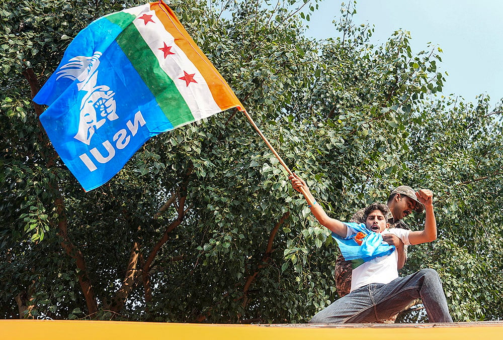 Security personnel detain National Students' Union of India (NSUI) activists during a protest demanding immediate resignation of Chief Election Commissioner (CEC) Gyanesh Kumar, at Connaught Place, in New Delhi, Tuesday, Oct. 13, 2026.  - | Photo: PTI/Salman Ali