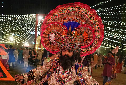 A man in traditional attire performs Gujarat state's folk dance called Garba during the celebration of nine nights Hindu festival Navratri, in Ahmedabad, Monday, Oct. 12, 2026. 
