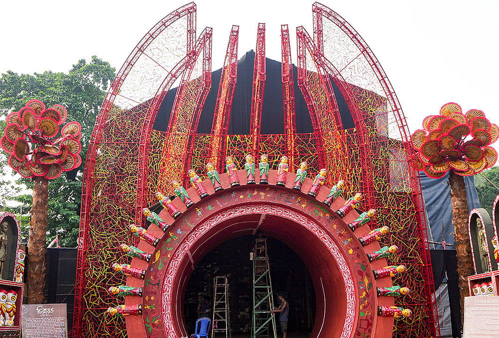 A worker decorates a community Durga Puja pandal ahead of the festival, in Kolkata, West Bengal, Tuesday, Oct. 13, 2026.  - | Photo: PTI/Swapan Mahapatra