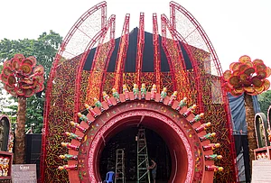 | Photo: PTI/Swapan Mahapatra : A worker decorates a community Durga Puja pandal ahead of the festival, in Kolkata, West Bengal, Tuesday, Oct. 13, 2026.