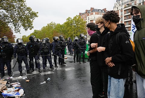 Students face police in front of the Helene Boucher high school as they protest against under-resourced schools in Paris, Tuesday Oct. 13, 2026. 
