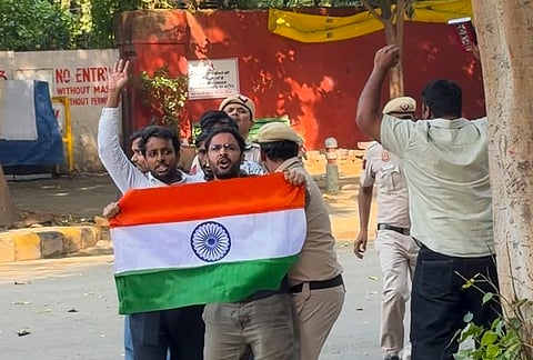 CJP leader Ashutosh Ranka and other workers wave the national flag at Jantar Mantar before being detained by police, in New Delhi. 