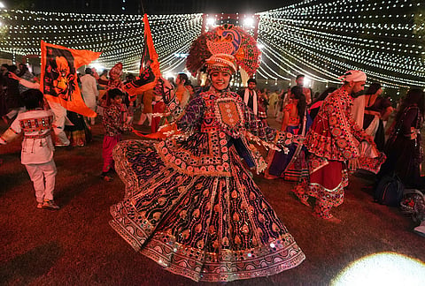 People in traditional attire perform Gujarat state's folk dance called Garba during the celebration of nine nights Hindu festival Navratri, in Ahmedabad, Monday, Oct. 12, 2026. 
