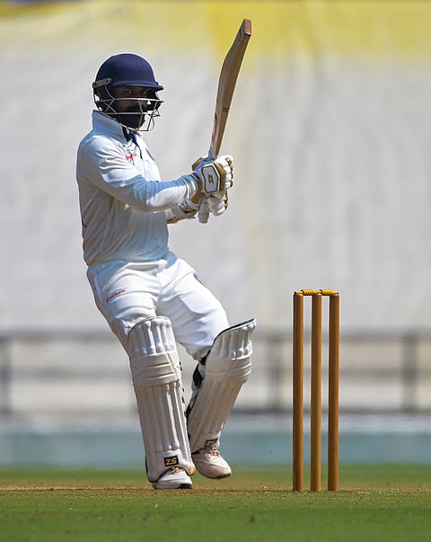 Puducherry's Nikhil Gangta lifts his bat after completing his half-century on the third day of the Ranji Trophy cricket match against Vidarbha at VCA Stadium, in Nagpur, Maharashtra.