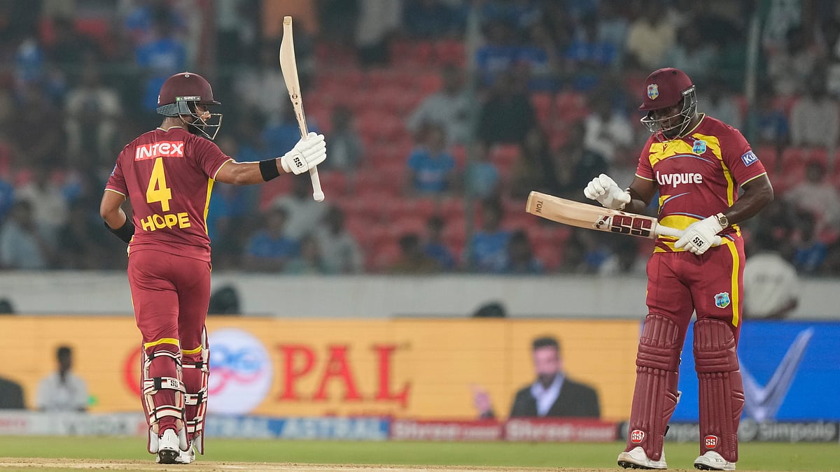 West Indies' captain Shai Hope, left, celebrates his fifty runs during the fourth T20 cricket match between India and West Indies in Hyderabad, India, Wednesday, Oct. 14, 2026 - (AP Photo/Mahesh Kumar A.)