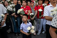 In Pictures: Vietnam Buries Remains Of 731 People Killed In 1968 Tet Offensive | Photo: AP/Thanh Hue : People watch as 731 sets of martyrs' remains found at Le Thi Rieng Cultural Park are transferred for burial at Ho Chi Minh City Martyrs' Cemetery Wednesday, Oct. 14, 2026, in Ho Chi Minh City, Vietnam.