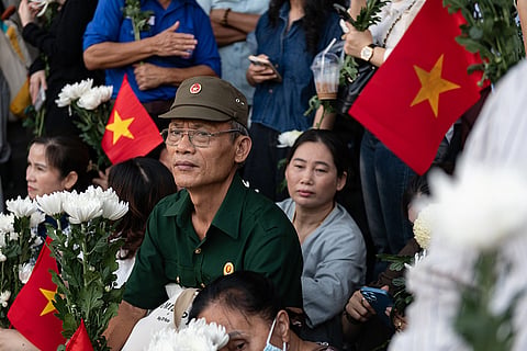 People watch as 731 sets of martyrs' remains found at Le Thi Rieng Cultural Park are transferred for burial at Ho Chi Minh City Martyrs' Cemetery Wednesday, Oct. 14, 2026, in Ho Chi Minh City, Vietnam.