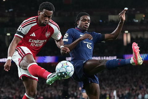 Arsenal's Jurrien Timber shoots by Lille's Nathan Ngoy during the UEFA Champions League soccer match between Arsenal and Lille in London, Tuesday, Oct. 13, 2026.