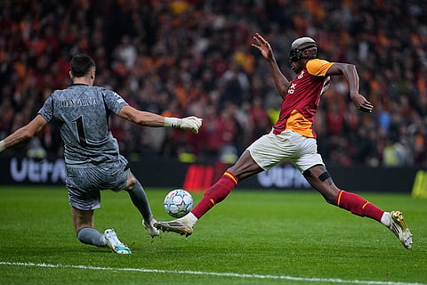 Galatasaray's Victor Osimhen, right, challenges Barcelona's goalkeeper Joan Garcia during the Champions League opening phase soccer match between Galatasaray and Barcelona in Istanbul, Turkey, Tuesday, Oct. 13, 2026.