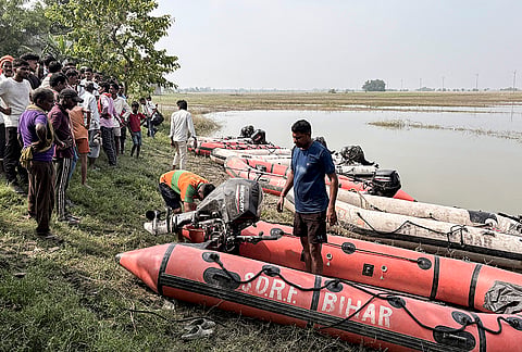 Rescue operation underway to trace any missing occupants of a boat that capsized in the Ganga River a day ago, resulting in the death of at least 13 children, at Hajipur, in Bihar's Vaishali district, Wednesday, Oct. 14, 2026. 

