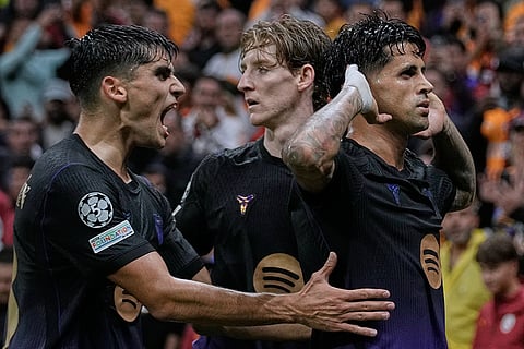 Barcelona's Joao Cancelo, right, celebrates with teammates after scoring his side's first goal during the Champions League opening phase soccer match between Galatasaray and Barcelona in Istanbul, Turkey, Tuesday, Oct. 13, 2026.