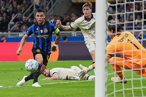 Inter Milan's Lautaro Martinez, left, scores his side's opening goal during the Champions League opening phase soccer match between Inter Milan and Club Brugge in Milan, Italy, Tuesday, Oct. 13, 2026.