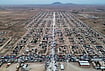 In Photos | Syrian Families Return To Ras al-Ayn After Seven Years, Find Homes In Ruins | Photo: AP/Baderkhan Ahmad : Trucks packed with belongings line the roads at al-Talayi camp as displaced families get ready to return to the Ras al-Ayn countryside, in Hassakeh, Syria, Tuesday, Oct. 13, 2026. Around 450 families are making the journey after seven years of displacement following a Turkish military offensive in 2019.