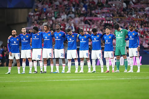 Manchester United players observe a moment of silence for late mother of Atletico Madrid's Koke before the Champions League opening phase soccer match between Atletico Madrid and Manchester United in Madrid, Tuesday, Oct. 13, 2026.