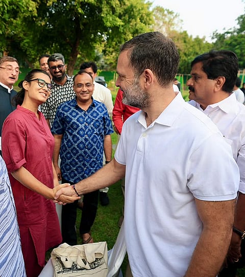 LoP in the Lok Sabha Rahul Gandhi greets All India Students' Association (AISA) National President Neha Bora during a high tea organised for the INDIA bloc leaders at the LoP’s residence, to discuss the strategy for joint protests against ‘vote chori’ (vote theft) and to press for Chief Election Commissioner Gyanesh Kumar's resignation, in New Delhi. 