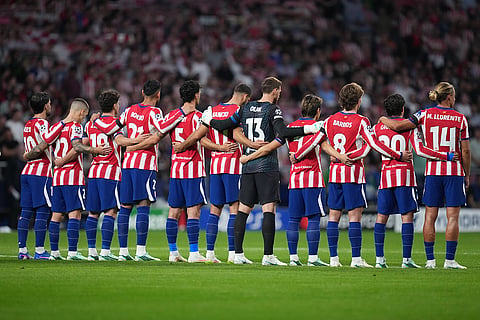Atletico Madrid players observe a moment of silence for late mother of Atletico Madrid's Koke before the Champions League opening phase soccer match between Atletico Madrid and Manchester United in Madrid, Tuesday, Oct. 13, 2026.