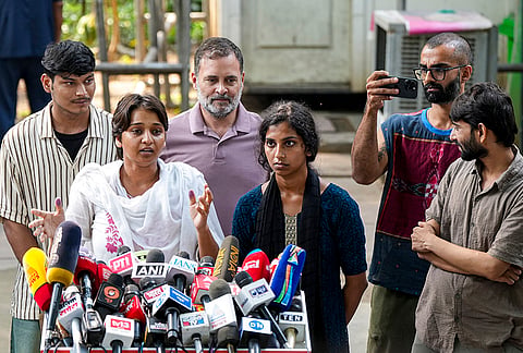 Congress leader Rahul Gandhi with content creator Ramit Verma, NSUI members and other protesters, who were allegedly injured amid crackdown by police in the recent protests against Chief Election Commissioner (CEC) Gyanesh Kumar, during a press conference after their meeting, in New Delhi, Wednesday, Oct. 14, 2026. 
