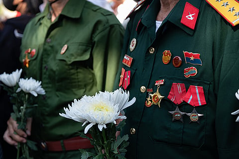 People watch as 731 sets of martyrs' remains found at Le Thi Rieng Cultural Park are transferred for burial at Ho Chi Minh City Martyrs' Cemetery Wednesday, Oct. 14, 2026, in Ho Chi Minh City, Vietnam.