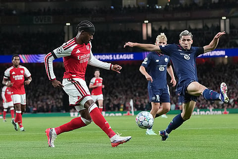 Lille's Romain Perraud blocks Arsenal's Noni Madueke during the UEFA Champions League soccer match between Arsenal and Lille in London, Tuesday, Oct. 13, 2026.