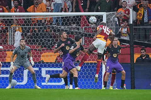 Galatasaray's Victor Osimhen, top, heads the ball against Barcelona defenders during the Champions League opening phase soccer match between Galatasaray and Barcelona in Istanbul, Turkey, Tuesday, Oct. 13, 2026.