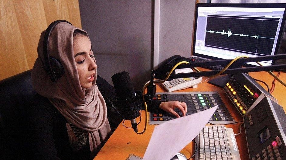 An Afghan journalist records a radio programme in a studio, illustrating the role of radio in news access in Afghanistan -  | United Nations