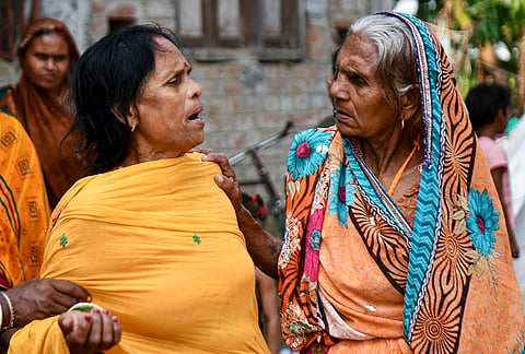 Family members of children who died after a boat capsized in the Ganga River a day ago, mourn, at Hajipur, in Bihar's Vaishali district, Wednesday, Oct. 14, 2026. 
