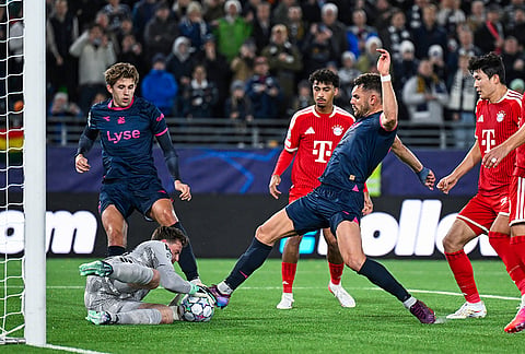 Bayern Munich's goalkeeper Jonas Urbig makes a save after an attempt by Viking's Gianni Stensness during the Champions League opening phase soccer match between Viking and Bayern Munich in Stavanger, Norway, Tuesday Oct. 13, 2026. 