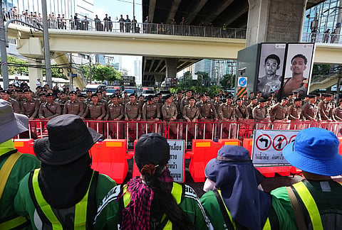 Protester stand near the meeting venue during a demonstration against International Monetary Fund and the World Bank Group in Bangkok, Thailand, Thursday, Oct. 15, 2026. 