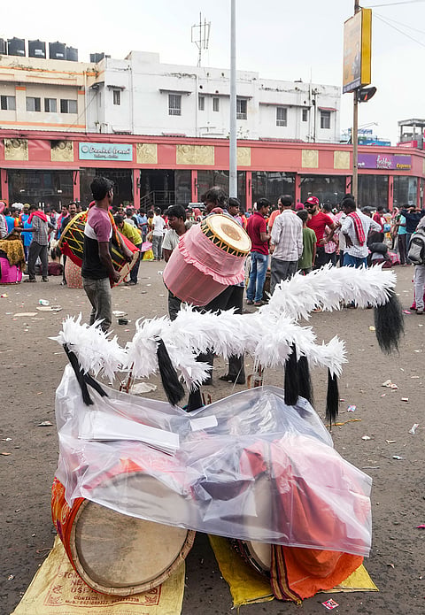 Dhakis, traditional Bengali drummers, display their skills as they arrive at Sealdah railway station from rural areas, hoping to be hired by Durga Puja committees for the remaining four days of the festival, in Kolkata, West Bengal, Thursday, Oct. 15, 2026. 