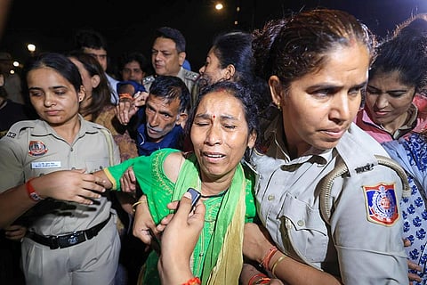 In this image posted on Oct. 15, 2026, Police personnel detain parents of 19-year-old Ankita Bhandari, who was murdered in Uttarakhand in 2022, while protesting near India Gate against Dushyant Kumar Gautam’s appointment as Sikkim governor, in New Delhi.