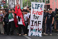 | Photo: AP/Sakchai Lalit : Protesters march to meeting venue during a demonstration against International Monetary Fund and the World Bank Group in Bangkok, Thailand, Thursday, Oct. 15, 2026. 