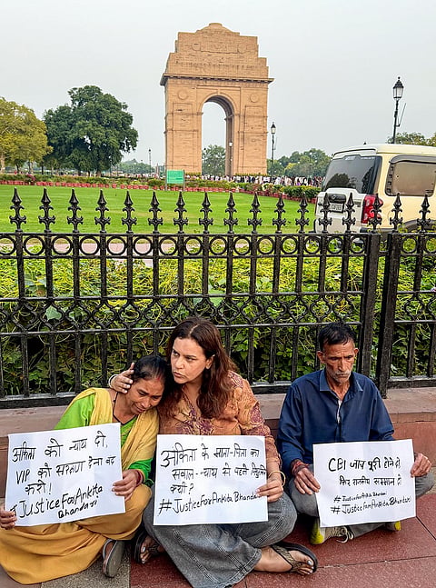Activist Yogita Bhayana, centre, with the parents of the deceased victim Ankita Bhandari stage a sit-in protest at India Gate demanding justice for their daughter, in New Delhi, Wednesday, Oct. 14, 2026. Bhandari was killed at Vanantra Resort in Rishikesh on Sept. 18, 2022, and her body was recovered from the Chilla canal four days later; resort owner Pulkit Arya, son of former BJP leader Vinod Arya, and two accomplices were sentenced to life imprisonment for the murder.