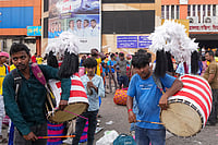 In Photos: From Village To Platform, Dhakis Bring Puja Rhythms To Kolkata | Photo: PTI/Swapan Mahapatra : Dhakis, traditional Bengali drummers, display their skills as they arrive at Sealdah railway station from rural areas, hoping to be hired by Durga Puja committees for the remaining four days of the festival, in Kolkata, West Bengal, Thursday, Oct. 15, 2026.