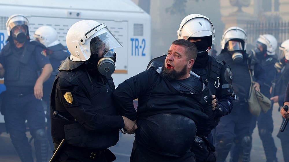Riot police detain a protester during clashes near the Ministry of Education in Tirana, Albania, joining a demonstration organised by the Flamingo protest movement demanding the resignation of Prime Minister Edi Rama. 
 - | Photo: AP/Hameraldi Agolli