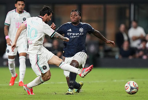 Inter Miami forward Lionel Messi (10) attempts a shot on the goal as New York City FC defender Tayvon Gray, right, defends during the second half of an MLS soccer match, Wednesday, Oct. 14, 2026, in Miami. 