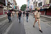 In Photos: Punjab Bandh Over Anti-Drug Activist Parvinder Jhota’s Murder | Photo: PTI/Shiva Sharma : Punjab Police personnel keep vigil during a bandh called to protest the killing of anti-drug activist Parvinder Singh alias Jhota in Mansa, in Amritsar, Punjab, Thursday, Oct. 15, 2026.