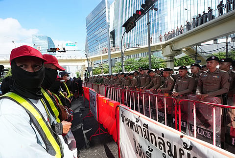 Protesters stand outside the meeting venue during a demonstration against International Monetary Fund and the World Bank Group in Bangkok, Thailand, Thursday, Oct. 15, 2026. 