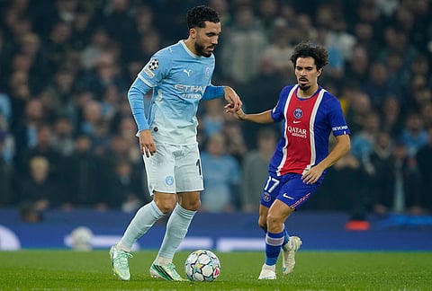 Manchester City's Rayan Cherki is challenged by PSG's Vitinha during the Champions League opening phase soccer match between Manchester City and Paris Saint-Germain in Manchester, England, Wednesday, Oct. 14, 2026. 
