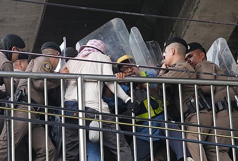 Police officers push protesters during a demonstration march to the International Monetary Fund and the World Bank Group meetings in Bangkok, Thailand, Thursday, Oct. 15, 2026. 