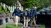 AP Photo/J. Scott Applewhite : Homeland Security officers leave the Washington residence of Rep. Ilhan Omar, D-Minn., after a search