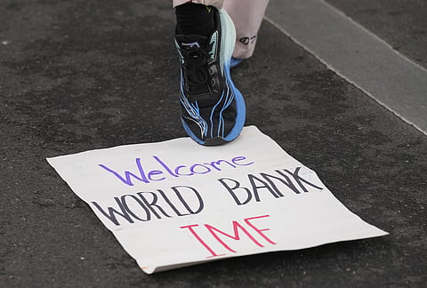 A sign from a protest against the International Monetary Fund and the World Bank Group lies on the floor in Bangkok, Thailand, Thursday, Oct. 15, 2026. 
