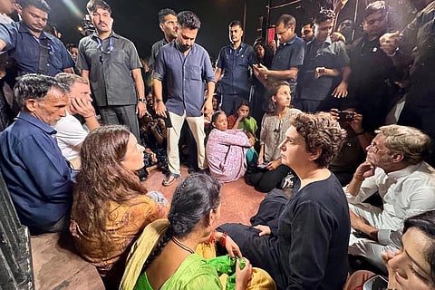 In this image posted on Oct. 14, 2026, Lok Sabha Leader of Opposition (LoP) Rahul Gandhi and Priyanka Gandhi Vadra join the parents of Ankita Bhandari during a sit-in protest at India Gate, in New Delhi. LoP Rahul Gandhi and Priyanka Gandhi joined the family to express solidarity with their demand to put on hold the gubernatorial appointment of a BJP leader whose name they allege is linked to the case.